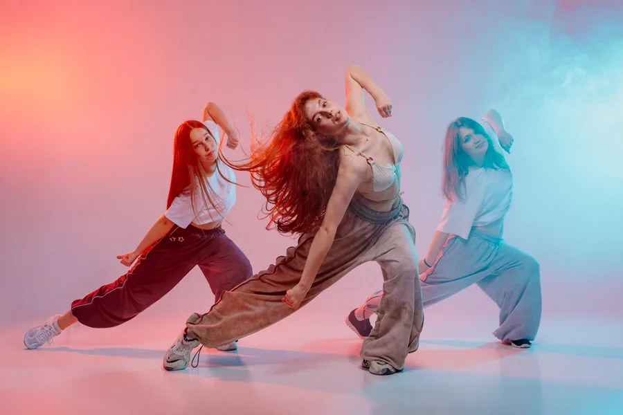Three young women dancing jazz funk in studio with 2026 03 2 — Pole Fitness Studio Las Vegas