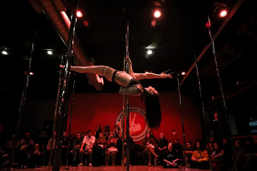Pole splits performed above the audience at Pole Fitness Studio in Las Vegas